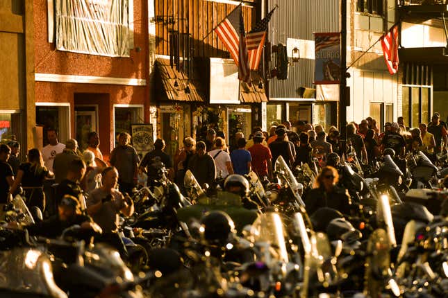 People walking along Main Street during the 80th Annual Sturgis Motorcycle Rally in Sturgis, South Dakota on August 8, 2020.