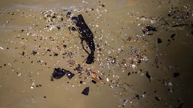 Tar pieces, trash, from an oil spill floats in the Mediterranean sea as it reached Gador nature reserve near Hadera, Israel.