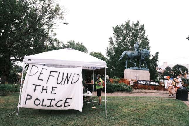 A banner that reads “Defund The Police” is seen during the “Reclaim the Park” gathering at Emancipation Park on August 12, 2020 in Charlottesville, Virginia.