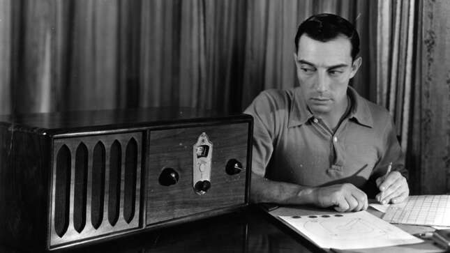 circa 1925: Buster Keaton (1895 - 1966), the American film comedian who started his career in Hollywood in 1917, timing his comedy scripts against radio music.