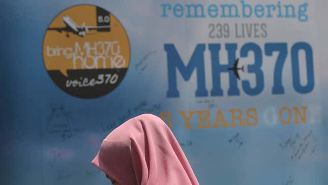 A girl stands in front of a condolence message board during a Day of Remembrance for MH370 event in Kuala Lumpur, Malaysia, Sunday, March 3, 2019. Five years ago, Malaysia Airlines Flight MH370, a Boeing 777, had gone missing the day before while over the South China Sea with 239 people on board.