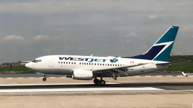 A Westjet plane lands at La Guardia International Airport in New York on July 29, 2018.