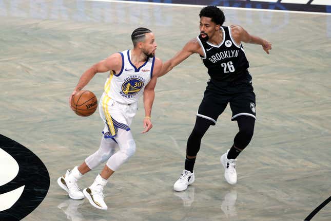 Stephen Curry #30 of the Golden State Warriors dribbles against Spencer Dinwiddie #26 of the Brooklyn Nets during the first half at Barclays Center on December 22, 2020 in the Brooklyn borough of New York City. 