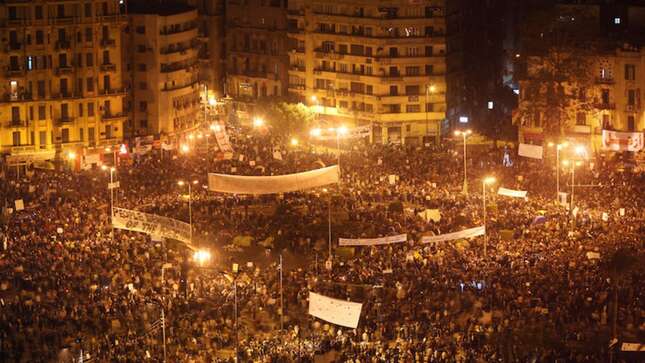 Anti-government protestors defy the curfew in Tahrir Square on February 1, 2011 in Cairo, Egypt. Photo via Getty.