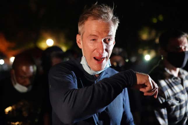 Portland Mayor Ted Wheeler reacts after being exposed to tear gas fired by federal officers while attending a protest against police brutality and racial injustice in front of the Mark O. Hatfield U.S. Courthouse on July 22, 2020, in Portland, Ore.