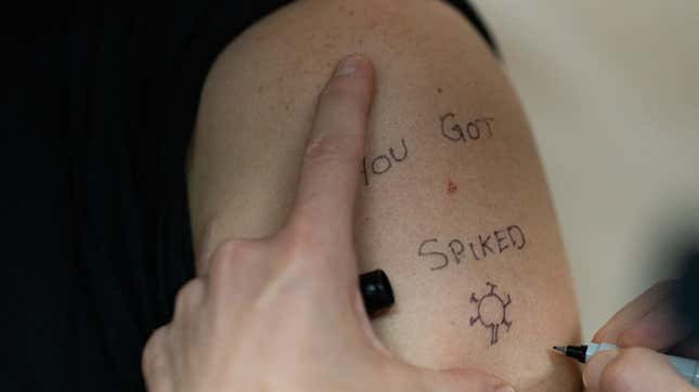 A nurse writes “You Got Spiked” around the spot where Alex Slog, a doctor at the Portland Veterans Affairs Medical Center, received his covid-19 vaccine on December 16, 2020 in Portland, Oregon. 