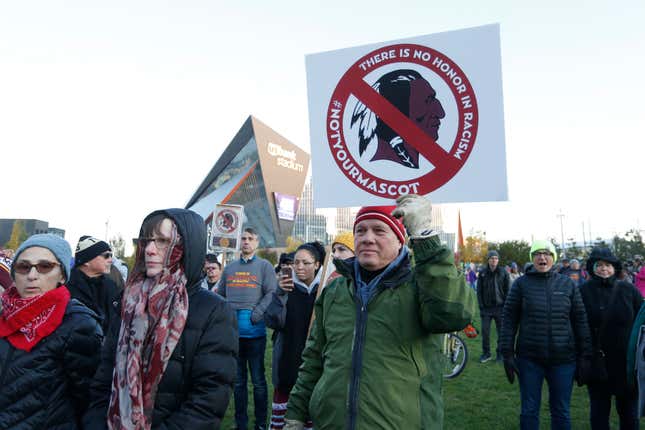 In this Oct. 24, 2019, file photo, Native American leaders protest against the Redskins team name outside U.S. Bank Stadium before an NFL football game between the Minnesota Vikings and the Washington Redskins in Minneapolis.