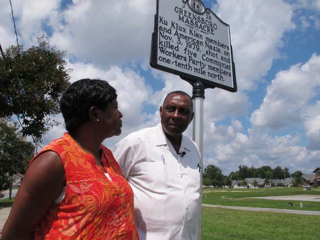 In this Aug. 16, 2017 photo, the Rev. Nelson Johnson and his wife, Joyce, stand beside a historical marker for the “Greensboro Massacre” in Greensboro, N.C. Near that spot on Nov. 3, 1979, Nazis and members of the Ku Klux Klan attacked marching workers, leaving five dead and Johnson injured.