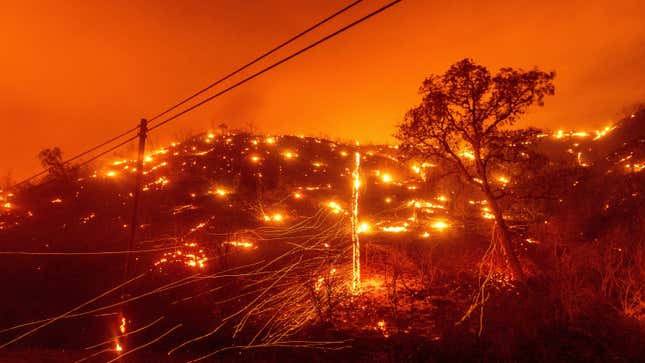 Seen in a long exposure photograph, embers burn along a hillside as the LNU Lightning Complex fires tear through Napa County on Tuesday, Aug. 18, 2020.