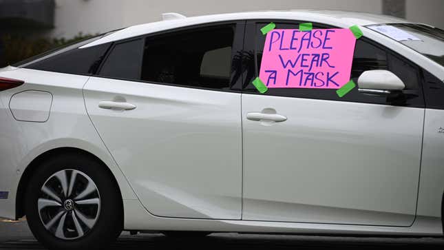 One of a group of cars drive along Ocean Blvd in Santa Monica, California with signs reading “Please Wear A Mask,” July 25, 2020. - The free blood tests were offered by appointment to anybody without COVID-19 symptoms by the Buddhist Tzu Chi Foundation and Medical Task Force International, two US-based charitable organisations. 