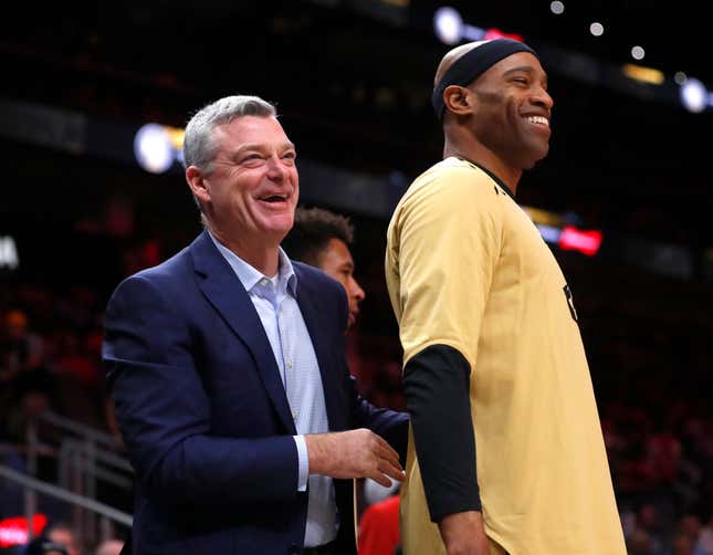 Atlanta Hawks owner Tony Ressler, left, speaks to forward Vince Carter before an NBA basketball game against the Indiana Pacers Wednesday, April 10, 2019, in Atlanta.
