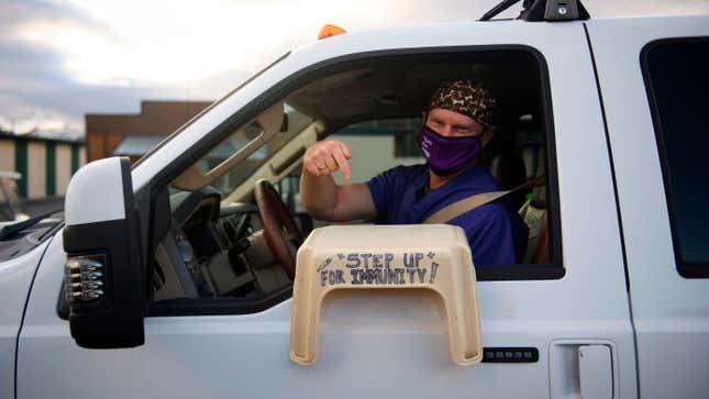 Dr. Bret Frey, an emergency medicine physician, points to a step stool he brought so a nurse could reach their arm inside a truck to administer the first dose of the Pfizer-BioNTech covid-19 vaccine under an emergency use authorization at a drive-up vaccination site from Renown Health on December 17, 2020, in Reno, Nevada.