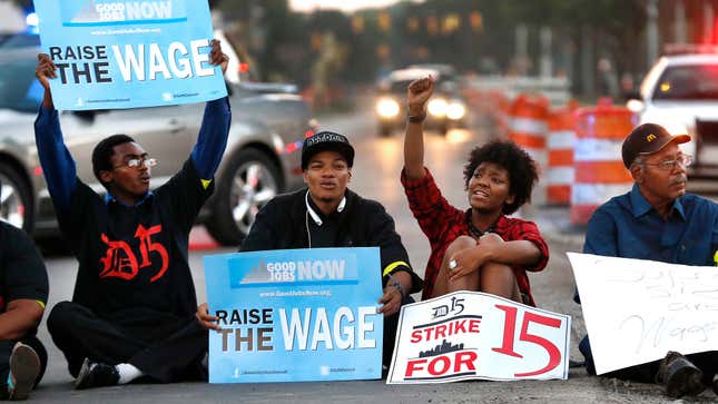 In this Sept. 4, 2014, photo, protesters block traffic on Mack Avenue in Detroit as part of a national protest to push fast-food chains to pay their employees at least $15 an hour. The labor group Fight for $15 is now backing sexual harassment claims against fast food behemoth McDonald’s in the latest push to hold big corporations more responsible for the welfare of their workers.