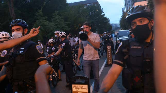 Police surround Jacob Wohl as he taunts protesters in DC on Aug. 27, 2020.