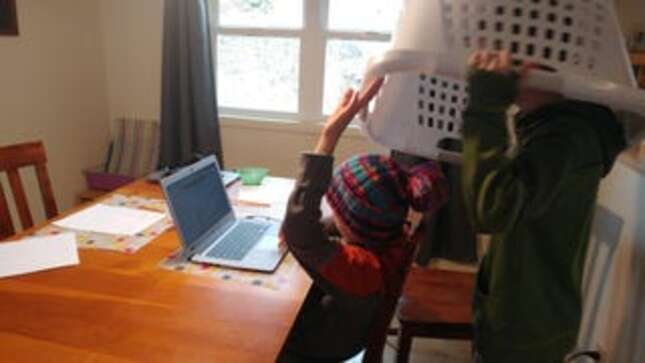 Jennifer’s kids. “Went to check on the boys after a midmorning video call for work and the younger was attempting to actually do schoolwork while the older was slowly lowering a laundry basket onto his head from behind,” she said.