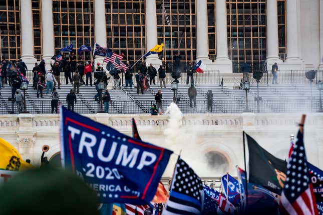 Supporters of US President Donald Trump clash with the US Capitol police during a riot at the US Capitol on January 6, 2021, in Washington, DC. - 