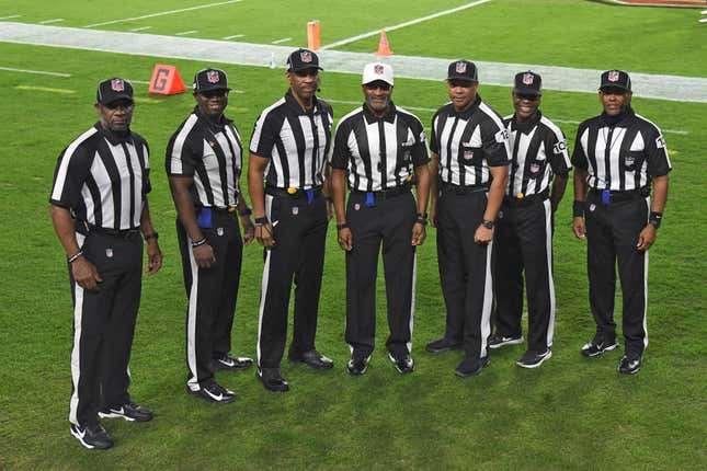 NFL officials, from left, umpire Barry Anderson, field judge Anthony Jeffries, down judge Julian Mapp, referee Jerome Boger, back judge Greg Steed, side judge Dale Shaw (104), line judge Carl Johnson (101) pose for a photo before an NFL football game between the Tampa Bay Buccaneers and the Los Angeles Rams Monday, Nov. 23, 2020, in Tampa, Fla.