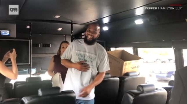 John Miller (center) boards a bus to take him home after being released from prison after 21 years. 