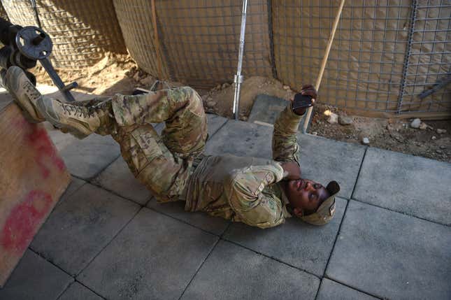 A U.S. Army soldier checking his phone in Afghanistan. 