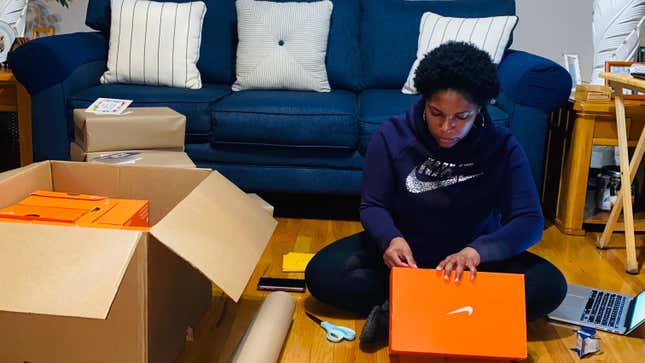 Ajón Crump checks a box of Nikes intended for shipping.