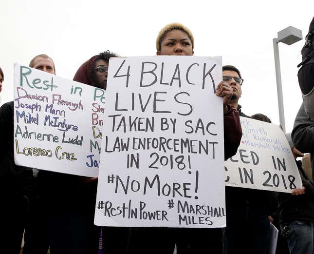 Chloe Compton, center, joins dozens of others in a demonstration outside the Sacramento Police Department to protest the decision to not prosecute the two officers involved in the 2018 fatal shooting of Stephon Clark, in Sacramento, Calif., March 2, 2019.