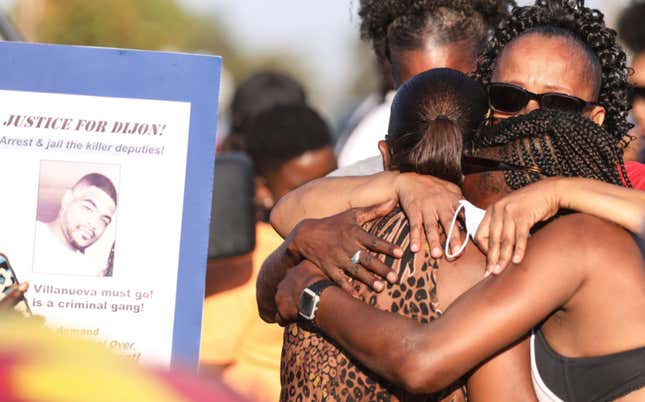 Debra Ray (L), aunt of Dijon Kizzee, is embraced after speaking near a makeshift memorial where Dijon Kizzee, a 29-year-old Black man, was killed by Los Angeles sheriff’s deputies in South Los Angeles on September 1, 2020 in Los Angeles, California. Protesters marched to the South Los Angeles Sheriffs’ Station to demonstrate for a second day after Kizzee was killed in an altercation after being stopped by police while riding his bicycle. 