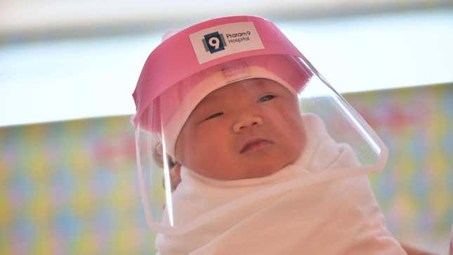 Image for article titled Here's a Slightly Crotchety Baby In the Tiniest PPE You've Ever Seen