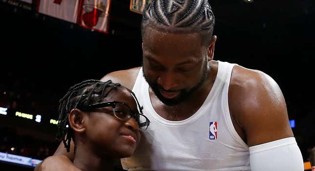 Dwyane Wade #3 of the Miami Heat hugs his son, Zion Wade, after his final career home game at American Airlines Arena on April 9, 2019, in Miami.