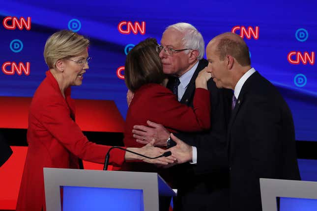 Democratic presidential candidates Sen. Elizabeth Warren (D-Mass.), left, greets former Maryland congressman John Delaney while Sen. Bernie Sanders (I-Vt.) hugs Sen. Amy Klobuchar (D-Minn.) after the Democratic Presidential Debate at the Fox Theatre July 30, 2019, in Detroit.