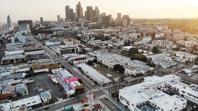 An aerial view of mostly empty streets and parking lots with the downtown skyline in the background amid the coronavirus pandemic on April 4, 2020 in Los Angeles, California.