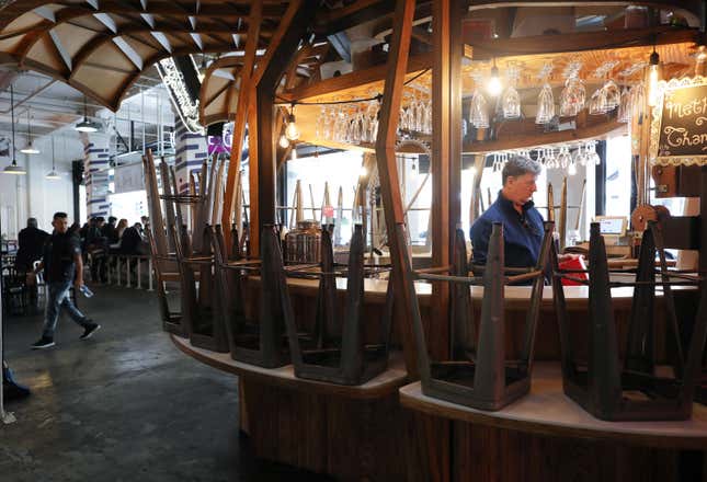  A bartender works at a bar in Grand Central Market on March 15, 2020 in Los Angeles, California