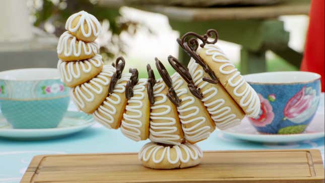 An elaborate cornucopia made of pastry, precariously balanced on a smaller pastry