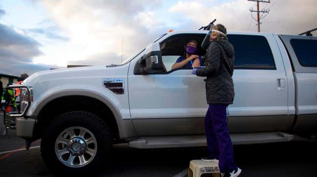 Dr. Bret Frey, an emergency medicine physician, talks with a nurse from inside a truck after receiving a first dose of the Pfizer/BioNTech covid-19 vaccine under an emergency use authorization at a drive-up vaccination site from Renown Health on December 17, 2020 in Reno, Nevada.