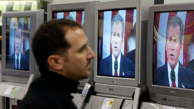 Yancey Wade, of San Francisco, watches U.S. President George W. Bush deliver the State of the Union address on a wall of televisions at a Best Buy store January 20, 2004 in San Francisco.