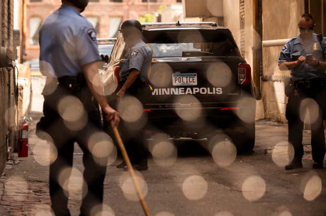 Members of the Minneapolis Police Department seen through a chain link gate on June 13, 2020 in Minneapolis, Minnesota. The MPD has been under scrutiny from residents and local city officials after the death of George Floyd in police custody on May 25. 