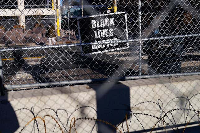 A lone Black Lives Matter sign hangs on the fence surrounding the Hennepin County Government Center, where the trial for former Minneapolis police officer Derek Chauvin continues on Monday, March 29. 