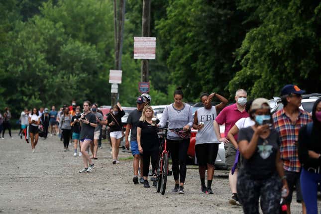 People wait in line to vote in Georgia’s primary election at Park Tavern on Tuesday, June 9, 2020, in Atlanta.