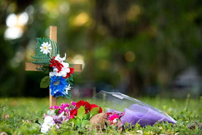 A cross with flowers sits near the intersection of Satilla Rd. and Holmes Rd. in the Satilla Shores neighborhood where Ahmaud Arbery was shot and killed May 7, 2020 in Brunswick, Georgia. Arbery was shot during a confrontation with an armed father and son on Feb. 23. 