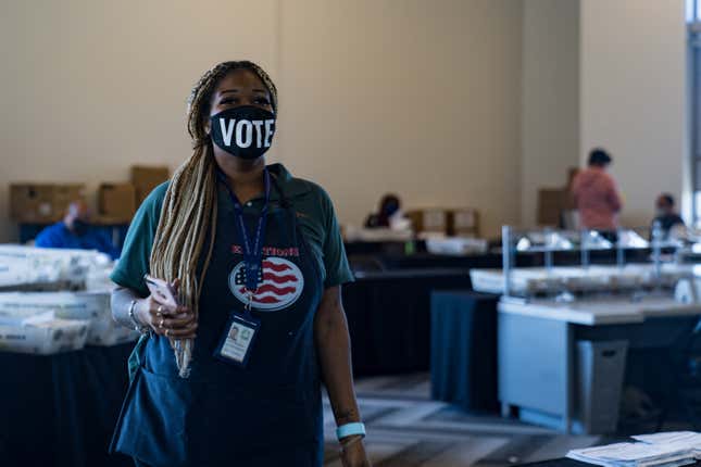  An election worker processes absentee ballots at State Farm Arena on November 2, 2020 in Atlanta, Ga.