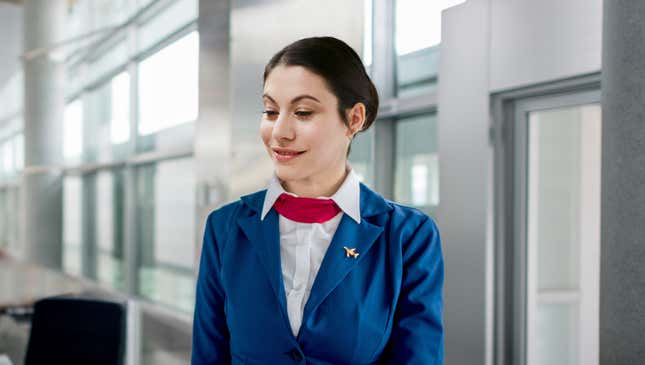 Image for article titled Flight Attendant Licks Her Lips As Traveler Approaches Gate With Large Suitcase