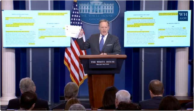 Sean Spicer holds up offensive tweet.