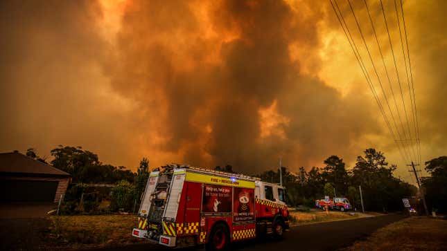 Firemen prepare as a bushfire approaches homes on the outskirts of the town of Bargo on December 21, 2019 in Sydney, Australia.