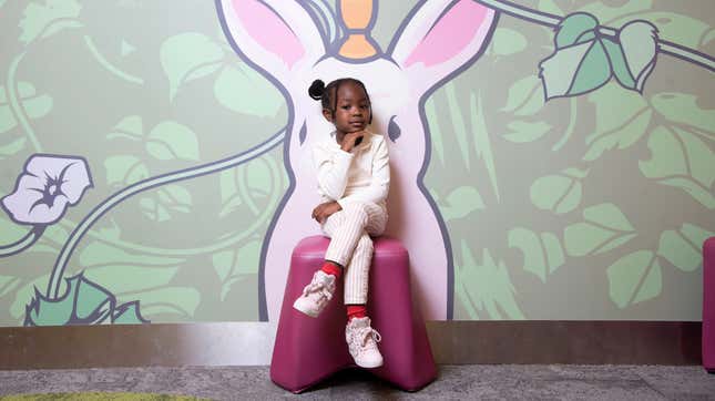 Parker Curry, 4, imitates Michelle Obama’s portrait pose at the West End Library in Washington, DC on October, 10, 2019.