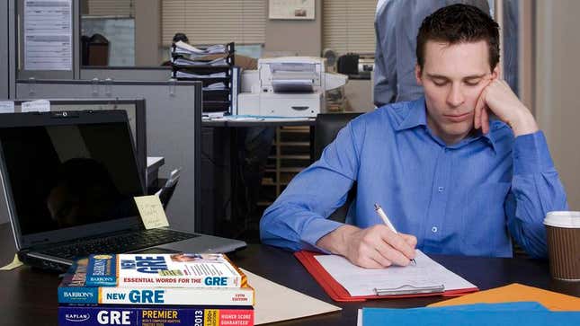 Image for article titled Frustrated Employee No Longer Even Trying To Hide GRE Study Books