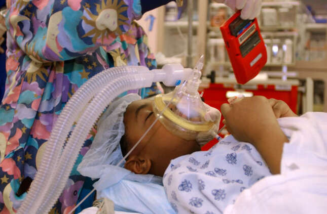 Dr. Anu Patel removes a Game Boy hand-held game from the hands of Nykia Crawford who was just sedated for an operation at University Hospital in Newark, N.J., Tuesday, Dec. 7, 2004.