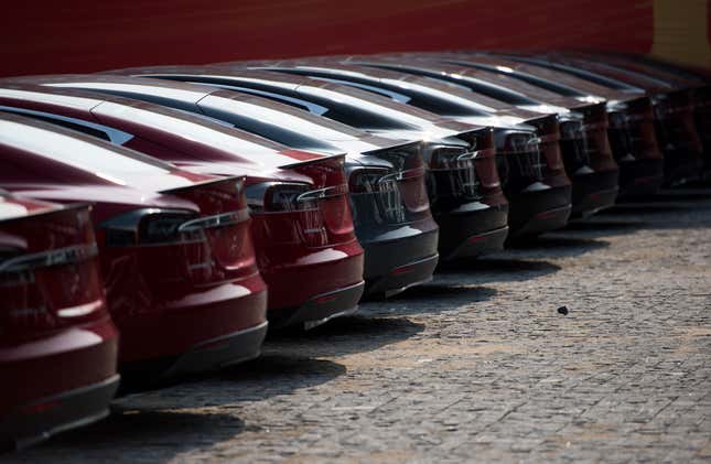 This picture taken on March 17, 2015, shows Tesla Model S vehicles parked outside a car dealership in Shanghai. 