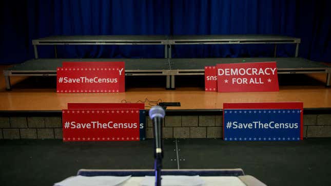 Signs sit behind the podium before the start of a press conference with New York’s then attorney general to announce a multistate lawsuit to block the Trump administration from adding a question about citizenship to the 2020 census form, April 3, 2018, in New York City. 