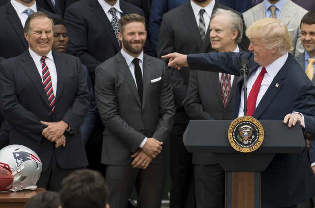 US President Donald Trump speaks alongside New England Patriots head coach Bill Belichick (L) and members of the team during a ceremony honoring them as 2017 Super Bowl Champions on the South Lawn of the White House in Washington, DC, April 19, 2017. 