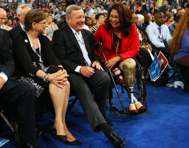 Include an image U.S. Sen. Dick Durbin (D-IL) (C) talks with then-Illinois nominee for Congress Tammy Duckworth (D) during day one of the Democratic National Convention at Time Warner Cable Arena on September 4, 2012 in Charlotte, North Carolina