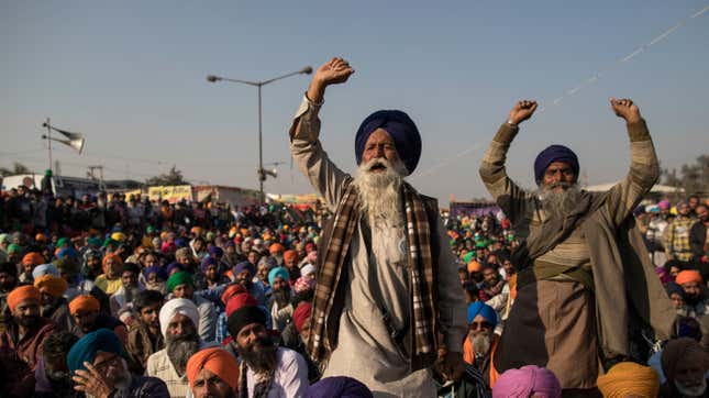 Farmers shout slogans as they participate in a protest at the Delhi Singhu border on December 18, 2020 in Delhi, India.